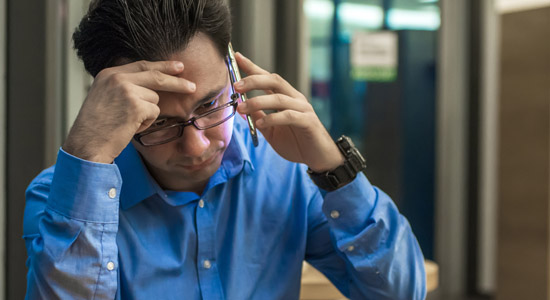 image of stressed man on cell phone